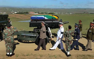 Nelson Mandela Laid to Rest in His Hometown - Former South African president Nelson Rolihlahla “Madiba” Mandela was laid to rest on a family plot at his ancestral burial grounds in the village of Qunu. The private traditional Xhosa burial marked the end of 10 days of mourning for Mandela which began on Dec. 5 when he died at the age of 95.(Photo: AP Photo/Elmond Jiyane, GCIS)