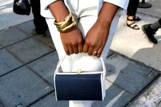 Classic Shapes - Paola keeps the ladylike charm alive by adding a thick gold statement cuff and a vintage square navy-and-white handbag.(Photo: Britt Middleton/BET)