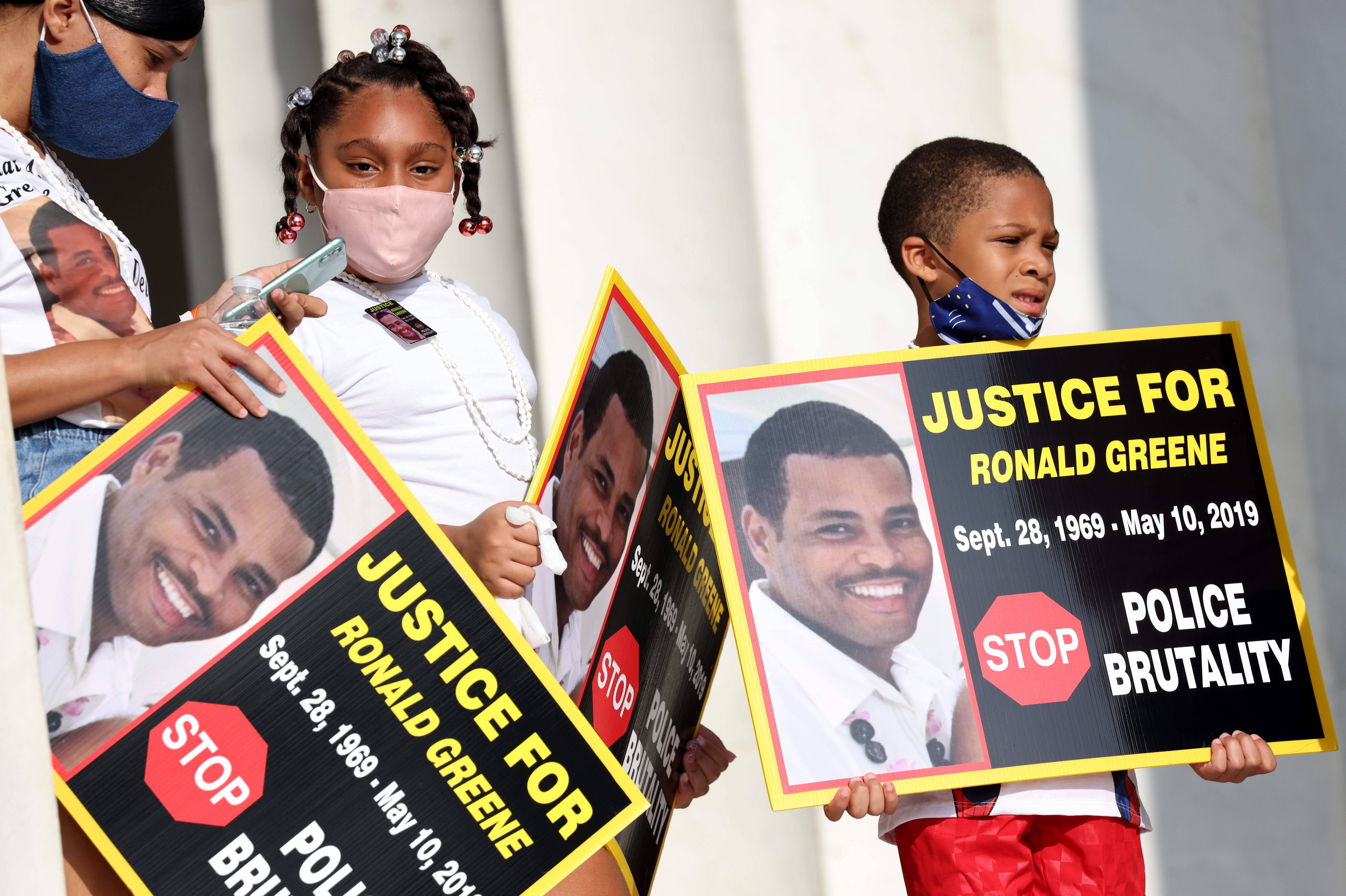 Family members of Ronald Greene listen to speakers during the "Commitment March: Get Your Knee Off Our Necks" protest against racism and police brutality, at the Lincoln Memorial on August 28, 2020, in Washington DC. Greene died in police custody following a high-speed chase in Louisiana in 2019. - Anti-racism protesters marched on the streets of the US capital on Friday, after a white officer's shooting of African American Jacob Blake. The protester also marked the 57th anniversary of civil rights leader Martin Luther King's historic "I Have a Dream" speech delivered at the Lincoln Memorial. (Photo by Michael M. Santiago / POOL / AFP) (Photo by MICHAEL M. SANTIAGO/POOL/AFP via Getty Images)