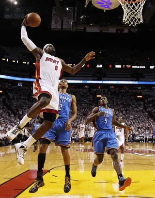 Nothin' But Net - James dunks over the Thunder's Thabo Sefolosha.&nbsp;(Photo: AP Photo/Mike Segar, Pool)