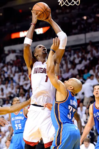 Stretch It Out - Oklahoma City's Derek Fisher attempts to block the Heat's Chris Bosh in Game 5 of the NBA Finals on Thursday.&nbsp;(Photo: Ronald Martinez/Getty Images)