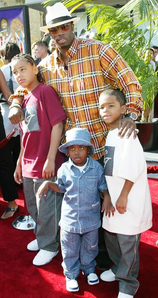 Diddy and His Children - Diddy kept it casual on the 2002 BET Awards red carpet with a plaid shirt, jeans, and cream fedora. He was joined by&nbsp;his children (L to R), Quincy, 11, Christian, 4, and Justin, 8.  (Photo: Frederick M. Brown/Getty Images)