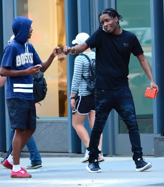 Dap It Up - A fan excitedly reaches out to give A$AP Rocky a pound on the streets of SoHo while the rapper walks and chats on his cell phone.&nbsp;(Photo: Splash News)