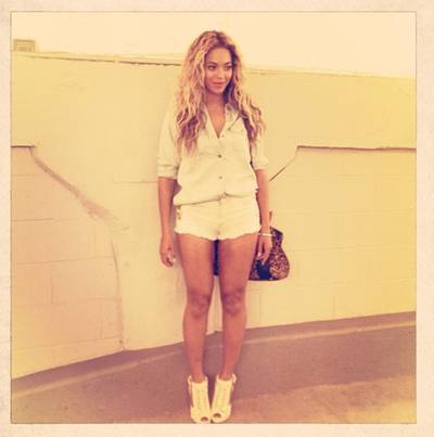 Summertime Fresh - Bey lightens up for the summer months in a light denim shirt, white cutoffs and peep-toe booties.  (Photo: Instagram via Beyonce)