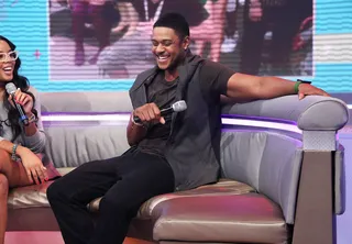 Just Smile - Pooch Hall (R) with host Angela Simmons cracking up on the couch. (Photo:&nbsp; Rob Kim/BET/Getty Images for BET)