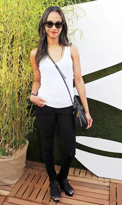 Zoe Saldana - File this look under “less is more.” Zoe Saldana makes a simple white tank, black skinnies and designer shades look hot for her visit to the Barclaycard Unwind VIP lounge in London.  (Photo: Dave M. Benett/Getty Images)&nbsp;