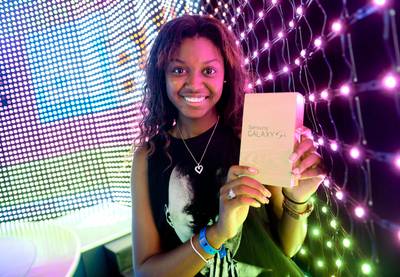 #Winning - Samsung Galaxy 4 phone winner Kiana Michel holds up her gift on 106. (Photo: John Ricard/BET/Getty Images for BET)