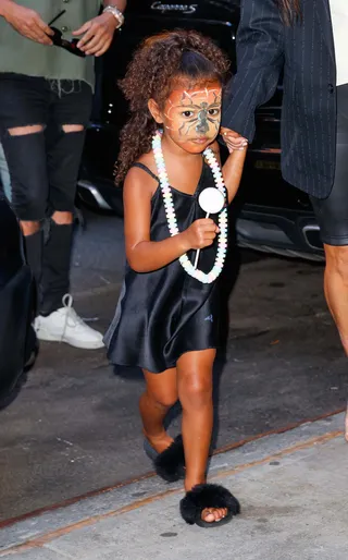 Mask On - Kim Kardashian's mini-me was seen out in NYC with a silk black dress and a face full of face paint. (Photo:&nbsp;Jackson Lee / Prahl Splash News)