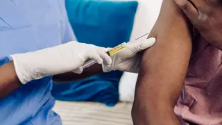 Unrecognizable African American young man receiving a Covid-19 vaccine.