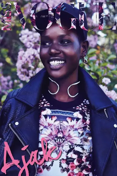 Ajak Deng - Flashing her signature grin, the Sudanese model gets us ready for spring, modeling a pretty floral top and tough leather jacket on&nbsp;Miss Vogue Australia.  (Photo: Miss Vogue Australia, April 2014)