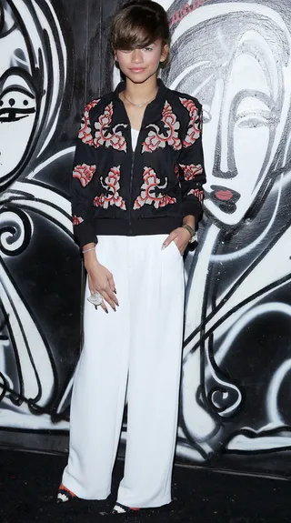 Easy and Breezy - This style chameleon always keeps us on our toes and we’re counting her printed sweater and wide-leg trousers as another win. We’re feeling her swooped bang and natural make-up, too.  (Photo: Rob Kim/Getty Images for alice + olivia by Stacey Bendet)