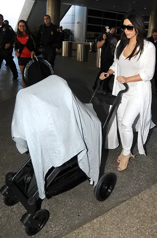 Jet Setters - Kim Kardashian and baby North make their way through LAX. These two are really racking up the air miles! (Photo: Vladimir Labissiere/Splash News)