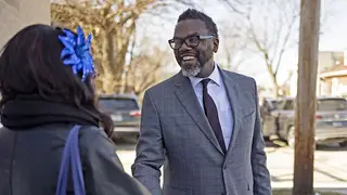 Mayoral candidate and Cook County Commissioner Brandon Johnson greets a voter after an appearance at Greater St. John Bible Church in the Austin neighborhood of Chicago on Feb. 26, 2023. 