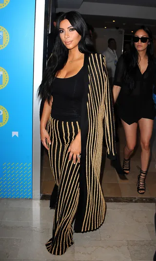 All That Glitters - Kim Kardashian sparkles in a black and gold two-piece pant suit by Balmain at the Cannes Lions Festival in France.(Photo: Gigi Iorio / Splash News)