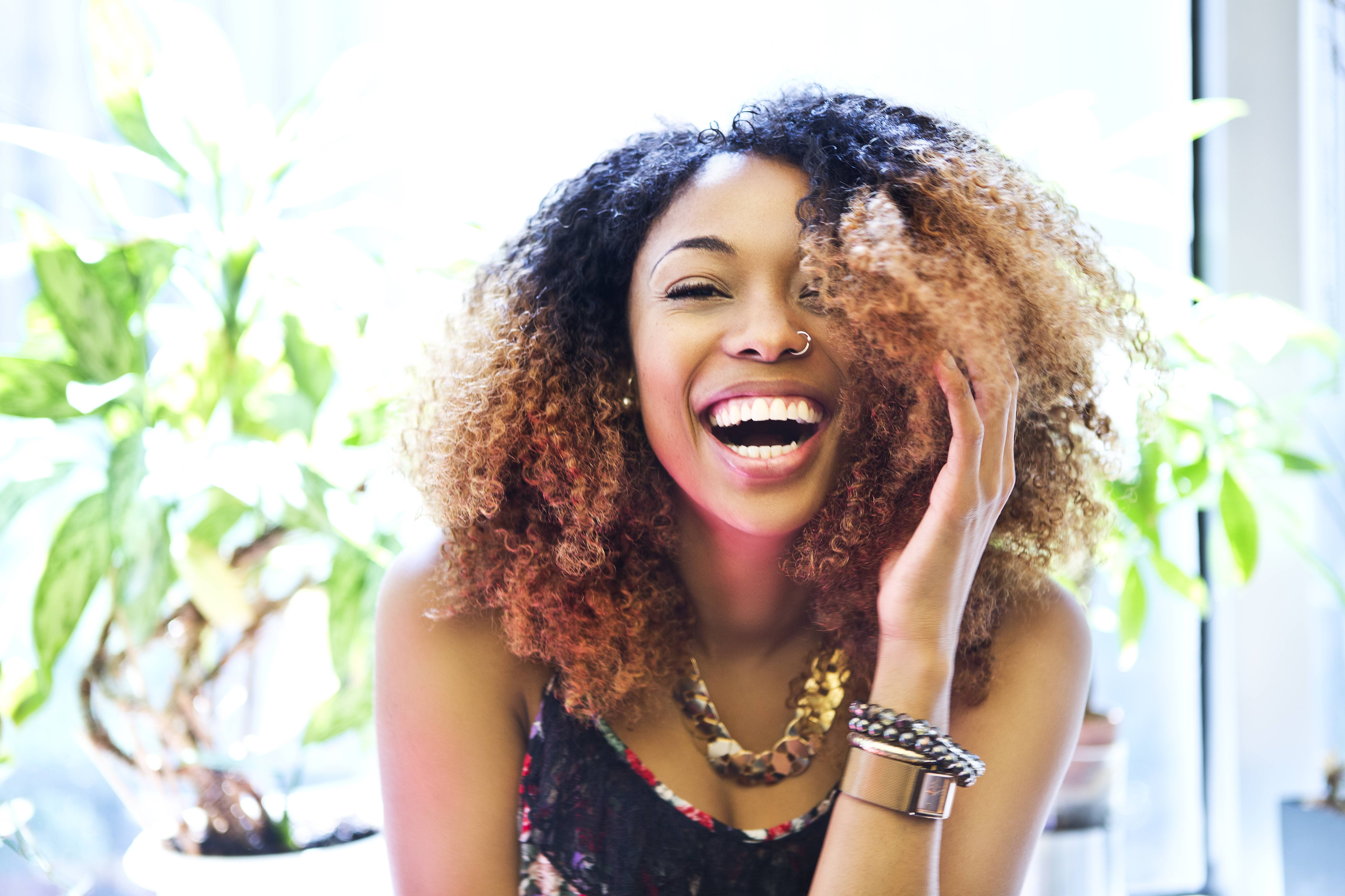 happy woman with curly hair smiling