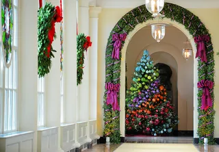 Colorful Tree - Wreaths of pine and stained glass cover windows in a long hallway leading to the East Garden room. The theme for the&nbsp;2012&nbsp;White House Christmas is Joy to All.(Photo: Bill O'Leary/The Washington Post)