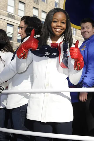 The Patriot - USA gymnastics gold medal Olympian Gabby Douglas gives a thumbs up to fans as she glides by the crowds enjoying the Macy's Thanksgiving Day Parade in New York City.(Photo: John Ricard)