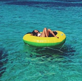 Lazy Day - A sun-bronzed Solo lets her troubles melt away as she drifts along the blue-green waters.  (photo: Solange Knowles via Instagram)