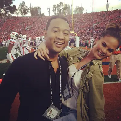 John Legend and Chrissy Teigen - The crooner and his swimsuit model wife stick to the basics—a black button-down for him and silky tank and military-style jacket for her—at the BCS Championship, where the Florida State Seminoles defeated the Auburn Tigers 34-31.  (Photo:&nbsp;Chrissy Teigen via Instagram)