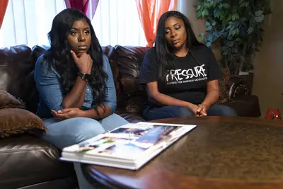Markeis McGlockton's sister Markeisha (left) and his mother Monica Moore-Robinson look at photos. - (Photo: Nathan Bolster/BET)