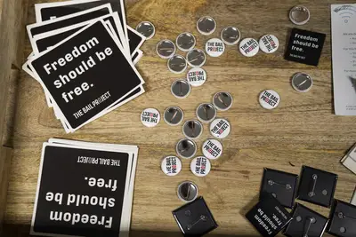 Buttons and fliers for The Bail Project are displayed. - (Photo: Nathan Bolster/BET)