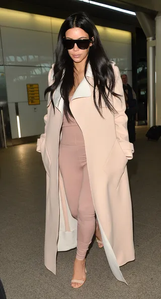 London Diva - A pregnant&nbsp;Kim Kardashian doesn't look too happy to see the paps upon arriving at Heathrow Airport in London.&nbsp;  (Photo: Palace Lee, PacificCoastNews)