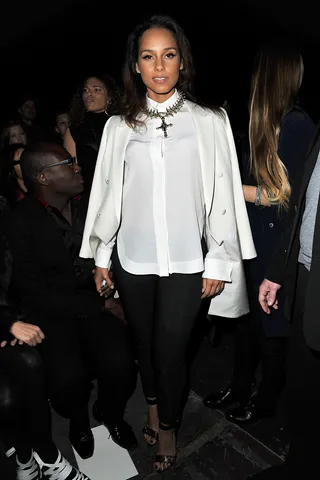 Alicia Keys - Keys looked every bit the celebrity, pairing a long Givenchy&nbsp;tuxedo jacket, white blouse, black cigarette-leg pants and strappy heels. She wore her tuxedo jacket over her shoulders like a cape and a bold cross necklace.  (Photo: Pascal Le Segretain/Getty Images)