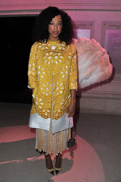 Sun Rae - British singer Corinne Bailey Rae sports a long sunburst embroidered coat and beautiful gold tip pointed-toe pumps as she arrives at the &quot;Louis Vuitton-Marc Jacobs: The Exhibition&quot; photocall, part of Paris Fashion Week at the Musée des Arts Décoratifs in Paris, France. (Photo: Pascal Le Segretain/Getty Images)