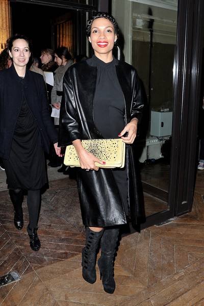 Just a Pop of Red - Rosario Dawson looks chic in her long leather coat, suede side button boots and bold red lips and nails as she arrives at the Yves Saint-Laurent Ready-To-Wear Fall/Winter 2012 show as part of Paris Fashion Week in Paris, France. (Photo: Pascal Le Segretain/Getty Images)
