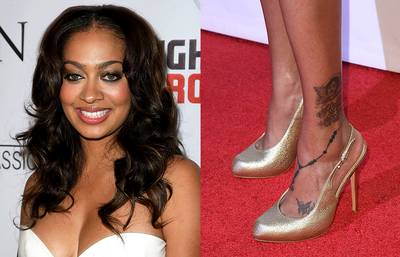 La La Anthony - La La’s bad girl tattoos actually reveal her inner good girl. Her rosary bead and cross tattoo runs from her ankle to her foot. It’s feminine and super sexy when paired with fly pumps.  (Photos: Noel Vasquez/Getty Images)