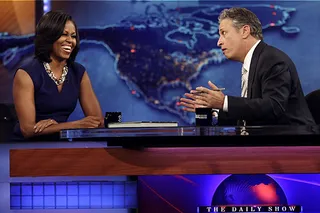 Late Night With Michelle Obama - Michelle Obama appeared on Comedy Central's The Daily Show where she gracefully deflected awkward questions from host Jon Stewart about her husband's past pot use to exposing her kids to the sometimes overly candid Vice President Joe Biden. “[Is] it hard to raise a kid around Biden?” Stewart quipped. “He's the uncle that comes over and you're like 'oh you brought them guns.'” The first lady responded that Biden's &quot;a great vice president and a great friend.&quot;  (Photo: Courtesy Comedy Central)