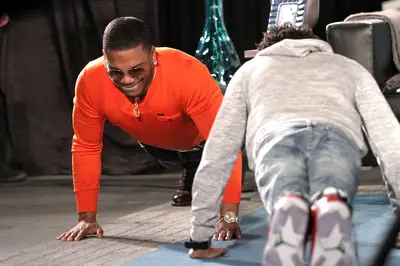 A Little Competition - Nelly shows Tre that he's still the man with the workout plan.   (Photo: Maury Phillips/WireImage)