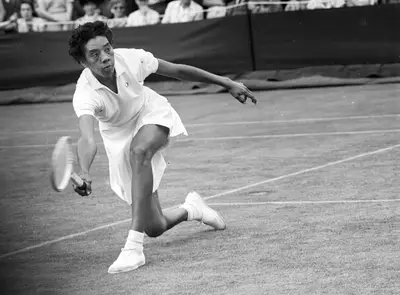 Althea Gibson - Tennis prodigy Althea Gibson conquered African-American tennis tournaments and, in 1950, she was given the opportunity to shatter even more records when she became the first African-American woman to compete at the U.S. Open. In 1951, she made her first appearance at Wimbledon. She was winner of the French Open in 1956, Wimbledon in 1957 and 1958, and the U.S. Open in 1957 and 1958.(Photo:&nbsp; Central Press/Getty Images)