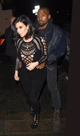 Love in London - Kim Kardashian and Kanye West get cuddly as they arrive at a West London recording studio following Yeezy's performance at the Brit Awards.(Photo: Evie Arabella/ Splash News)