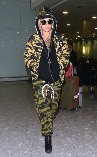 Low Pro - Rita Ora arrives at Heathrow Airport from Hong Kong in London rocking a BAPE camouflage shark sweat suit and shades.&nbsp;(Photo: Palace Lee, PacificCoastNews)