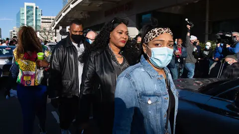 Fiancee Desiree Lindstrom (R) surrounded by family and friends of hospitalized rapper Earl Simmons, aka DMX, attends a prayer vigil hosted by the Ruff Ryders to the Rescue Foundation at White Plains Hospital on April 5, 2021 in White Plains, New York. - Gritty US rapper DMX was hospitalized and on life support on April 3 after a heart attack, his lawyer Murray Richman told AFP. 
"He was hospitalized at 11 o'clock last night at the hospital in White Plains," the New York suburb where he lives, after suffering "a heart attack," Richman, who has represented the rapper for 25 years, told AFP. (Photo by Angela Weiss / AFP) (Photo by ANGELA WEISS/AFP via Getty Images)