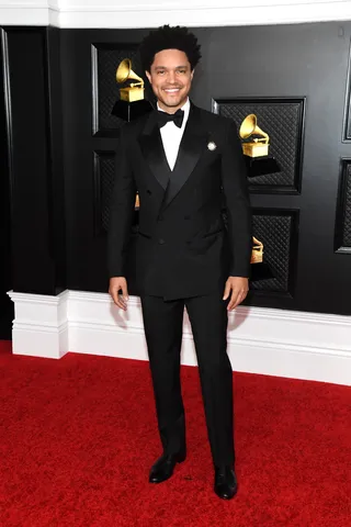 Trevor Noah was all smiles in his tailored Gucci suit. - (Photo by Kevin Mazur/Getty Images for The Recording Academy )