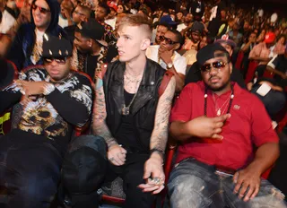 Flying High - MGK looks calm, laid back, and relaxed in his seat at the 2012 BET Hip Hop Awards, but we all know that he's really a wild boy. He's so wild that during his performance he was caught rapping from the ceiling. This guy has no limits! (Photo: Rick Diamond/Getty Images for BET)