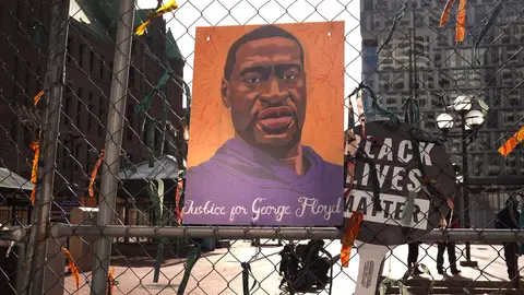 MINNEAPOLIS, MINNESOTA - MARCH 30: A picture of George Floyd hangs on a fence barrier that surrounds the Hennepin County Government Center as the trial of former Minneapolis police officer Derek Chauvin continues on March 30, 2021 in Minneapolis, Minnesota. Chauvin is accused of murder in the death of George Floyd. Security is heightened in the city in an effort to prevent a repeat of violence that occurred in Minneapolis and major cities around the world following Floyd's death on May 25, 2020.  (Photo by Scott Olson/Getty Images)