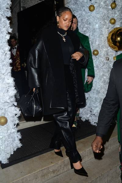 Lavish Leather - Rihanna popped out in London Monday night at a private member's club dressed head to toe in a black leather fit. Her warm, oversized Balenciaga faux leather coat ($3,600) was a perfect match, even down to her handbag. She tied the look together with stuning pendant and pearl necklaces.(Photo: Ricky Vigil M/GC Images)