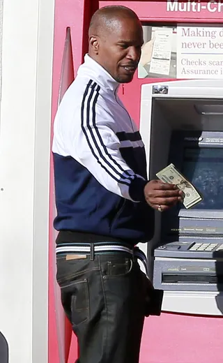 Cashin' Out - Django Unchained star Jamie Foxx stops by an ATM in Los Angeles and pretends to pay off the paparazzi. (Photo: FameFlynet, Inc)