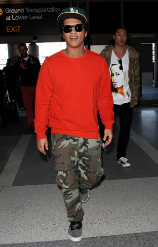 Caught Off Guard - The paparazzi catches pop singer Bruno Mars by surprise as he heads to catch a departing flight at LAX airport in Los Angeles. (Photo: FameFlynet, Inc)