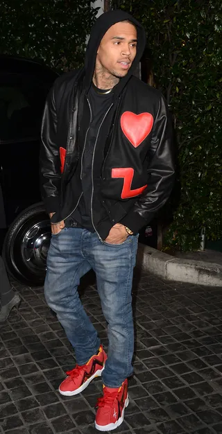 Aficionado - Aspiring fashion designer Chris Brown arrives at the Topshop Topman L.A. Opening Party ready for Valentine's Day while rocking a letterman's jacket embroidered with a red heart at Cecconi's West Hollywood in Los Angeles. (Photo: Jason Merritt/Getty Images)