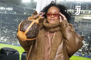 Ballin'&nbsp; - On Tuesday (Nov. 26),&nbsp;Rihanna&nbsp;attended a UEFA Champions League match in Turin, Italy wearing an oversized brown leather coat from her Fenty collection. Being the fashion maven she is, Rih paired the look with a pair of red shades and a priceless Louis Vuitton purse.(Photo:Giorgio Perottino - Juventus FC/Getty Images) (Photo: Giorgio Perottino - Juventus FC/Getty Images)