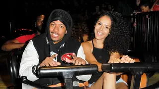 Actor Nick Cannon and Brittany Bell ride the 'Ghostrider' Roller Coaster at Knott's Berry Farm on September 1, 2017 in Buena Park, California. 