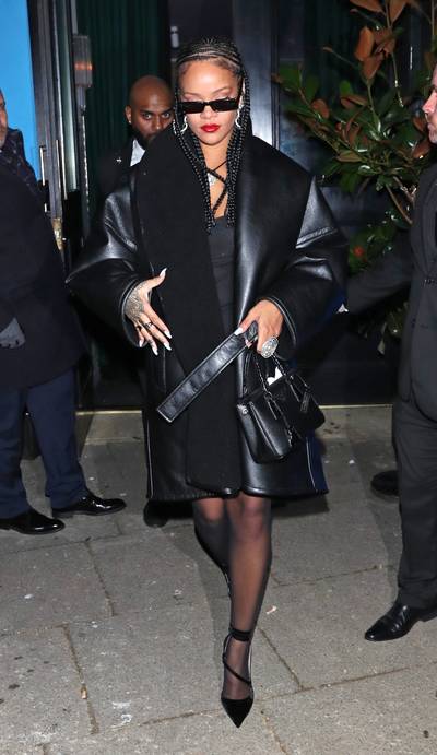 All Black RiRi - To celebrate her win, RiRi hosted an after party during the London Fashion Awards. She looked comfy cute and lowkey wearing the Balenciaga, cocoon, faux leather coat in black ($3,600), her new Fenty 'Trouble' sunglasses ($250) and the 'Galleria' Prada tote in black ($2,490). She finished off the look with her Fenty, tulle, black hoodie and custom black 'Date Night' pumps.(Photo: Backgrid)