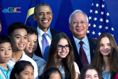 Students Meet the President - President Obama's trip to Malaysia marks the first visit to the nation by a U.S. president in nearly half a century. Here, the president posed for photographs with students visiting the Malaysian Global Innovation and Creativity Centre in Cyberjaya on Sunday, April 27.(Photo: AP Photo/Carolyn Kaster)