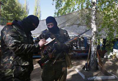 Three Killed At Pro-Russian Checkpoint - Russia blamed Ukraine nationalists for the April 20 fatal shooting of three people stationed at a pro-Russian checkpoint near Sloviansk. Nationalists denied any involvement, while Ukraine officials reported that it may have been a shootout between criminals.&nbsp;(Photo: AP Photo/Sergei Grits)