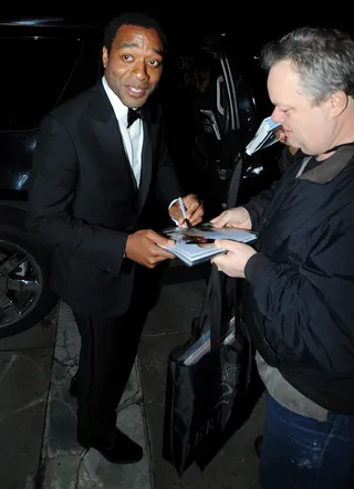 Fan-tastic - Chiwetel Ejiofor&nbsp;signs an autograph for an awaiting fan as he exits the venue after 12 Years a Slave won Best Picture at the Academy Awards.&nbsp; (Photo: Vladimir Labissiere/Splash News)