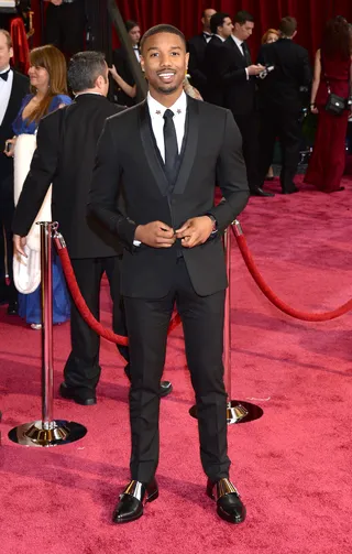 Michael B. Jordan  - The That Awkward Moment star is totally cool in his slim Givenchy suit and skinny tie.  (Photo: Michael Buckner/Getty Images)